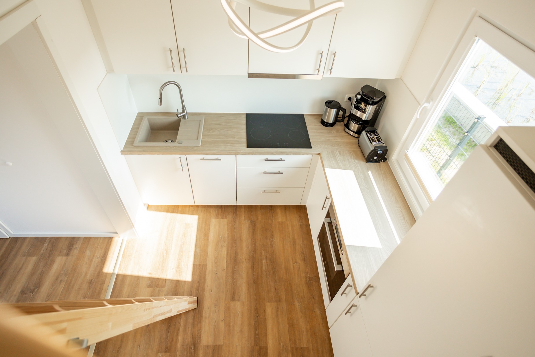 Küche Vogelperspektive Tiny House Ostsee – moderne Einbauküche mit Induktionskochfeld